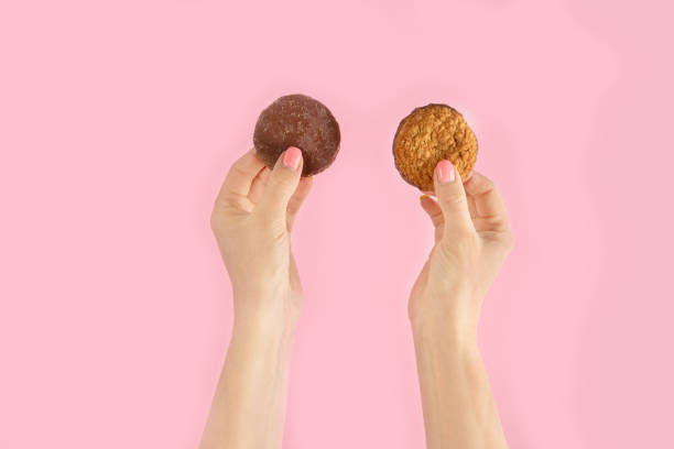 istock Arms raised up holding coffee cup on pink background. 1422948592