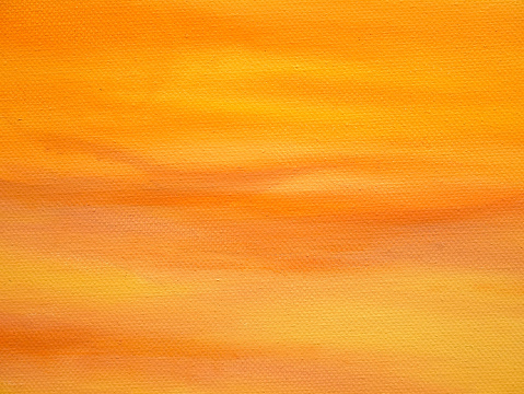 Orange colored acrylic painted on canvas texture for autumn designs background.