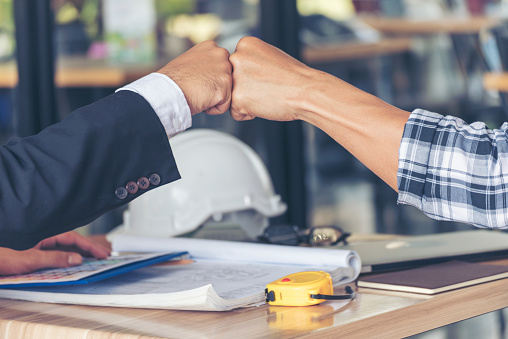 Two Men team fist bump Business Partner Businessman Trust Teamwork Partnership Industry contractor dealing mission business. Mission Business team meeting group of People Fist bump Hands together