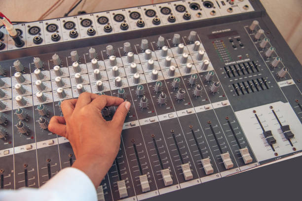 istock Production sound engineer woman hands adjusting volume equalizer voice, mixing console. DJ sound engineering working on recording studio mixing voice control.  Producer remix tune music sound record 1422952803