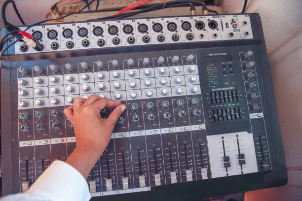 istock Production sound engineer woman hands adjusting volume equalizer voice, mixing console. DJ sound engineering working on recording studio mixing voice control.  Producer remix tune music sound record 1422952819