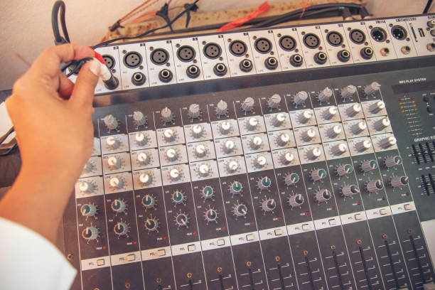 istock Production sound engineer woman hands adjusting volume equalizer voice, mixing console. DJ sound engineering working on recording studio mixing voice control.  Producer remix tune music sound record 1422952821