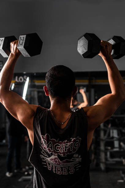 istock High quality photography. Man training with dumbells. 1422958120