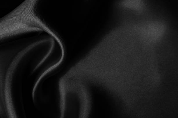 istock Black fabric cloth texture for background and design art work, beautiful crumpled pattern of silk or linen. 1422959491