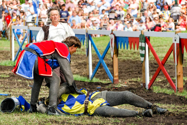 First aid to horseman at knights tournament Hever, United Kingdom - July 28, 2013: First aid to horseman at jousting event at Hever Castle in Kent, England Hever Castle stock pictures, royalty-free photos & images