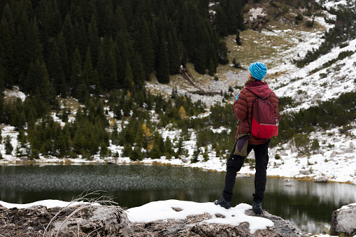 Mid Adult Woman Hiker Enjoying Winter Environment and Tranquillity near an Alpine Lake