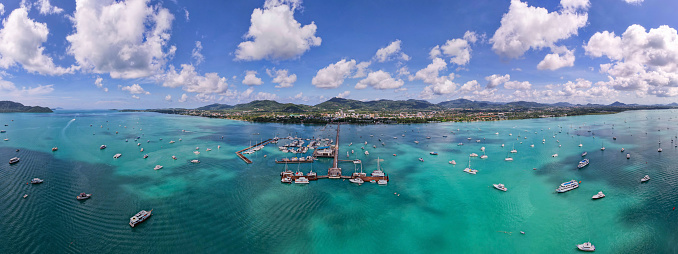 Panorama Chalong pier with sailboats and other boats at the sea,Beautiful image for travel and tour website design,Amazing phuket island view from drone panoramic landscape,Summer day