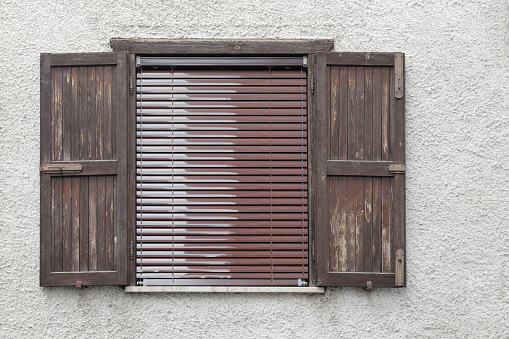 Front view old wooden green window with pink wall