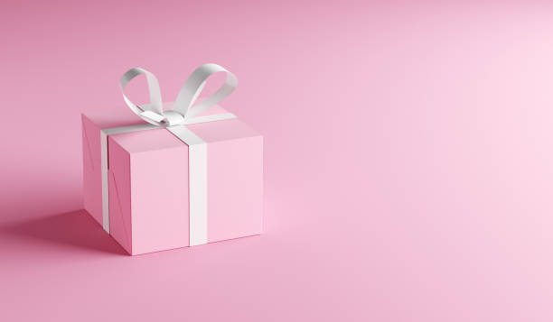 istock Pink gift box with white ribbon on pink background with copy space. 1422971600