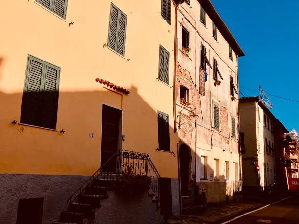 istock Colourful Tuscan houses bathing in sunlight with focus on shadows 1422978348