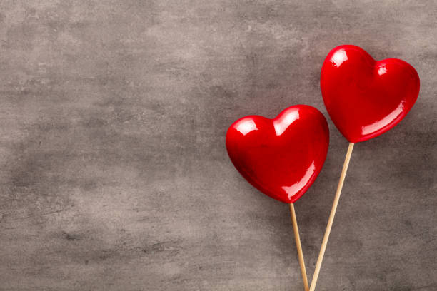 Valentine's Day, heart shaped lollipops on red background. Digitally generated image. 3d render.