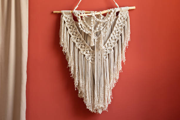 istock Wall panel in style of Boho made of cotton threads using the macrame technique for home decor and wedding decoration. Cozy Home decor concept. White Macrame in living room with boho interior design 1422978544