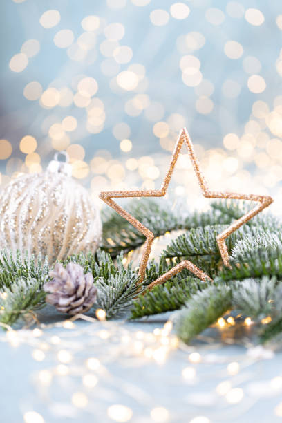 istock Christmas spruce with star and blurred shiny lights. 1422979749