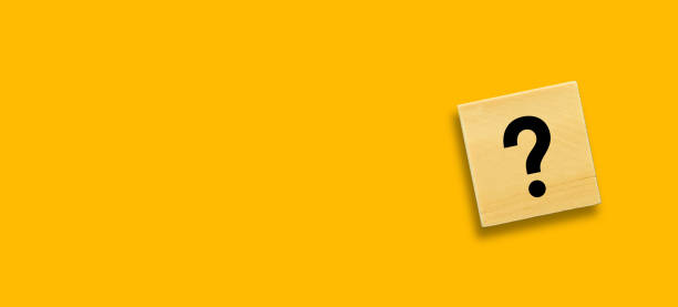 istock Question mark on wooden cube block with yellow background 1422980437