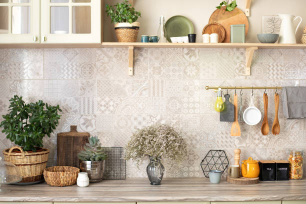 istock Kitchen tabletop with various ceramic jars and cookware. Ceramic plates, dishes, utensils and cozy decor. Stylish scandi cuisine interior decor. Bouquet of flowers vase at home. 1422981765