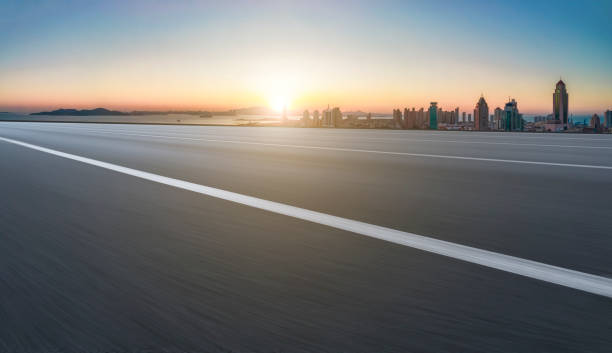istock Empty road and city buildings background 1422981892