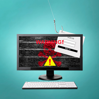 Warning sign on Desktop PC screen caused by cyber attack, on blue background.\nInformation security concepts.\nScam and phishing concepts.