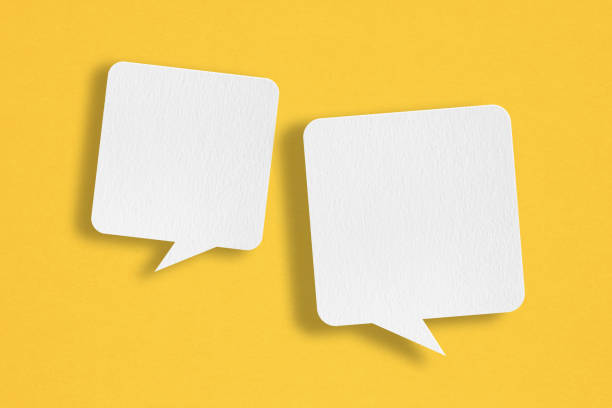 istock two blank white speech bubble   paper cut,  on grunge yellow paper background. Conceptual image about communication and social media 1422983955