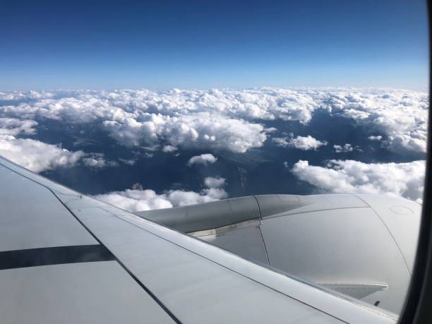 istock Blue sky white cloud airplane wing view from airplane window background 1422986793
