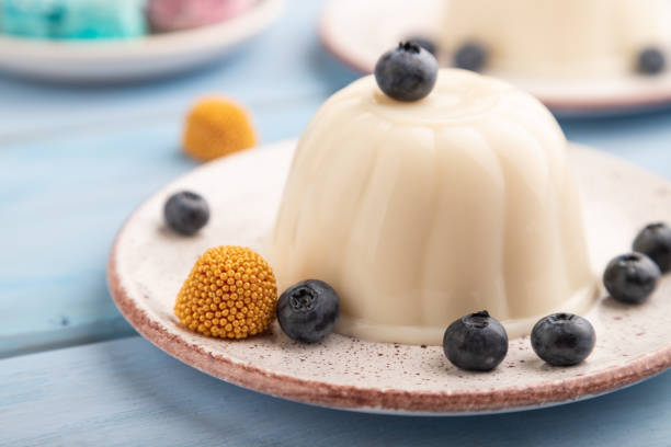 istock White milk jelly with blueberry on blue wooden,  side view, selective focus. 1422987557