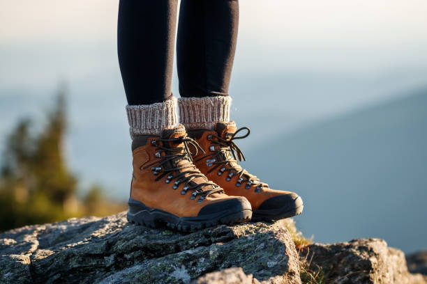 Leather hiking boots in mountain peak stock photo