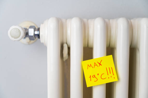 Radiator with ticket and text "max 19 ° C". stock photo