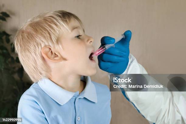 Kid Getting Polio Drops Doctor Making To Child Oral Vaccination Against Infection Little Blonde Hair Boy At Hospital Children Health Care And Disease Prevention Via Of Polio Vaccine Immunization Stock Photo - Download Image Now
