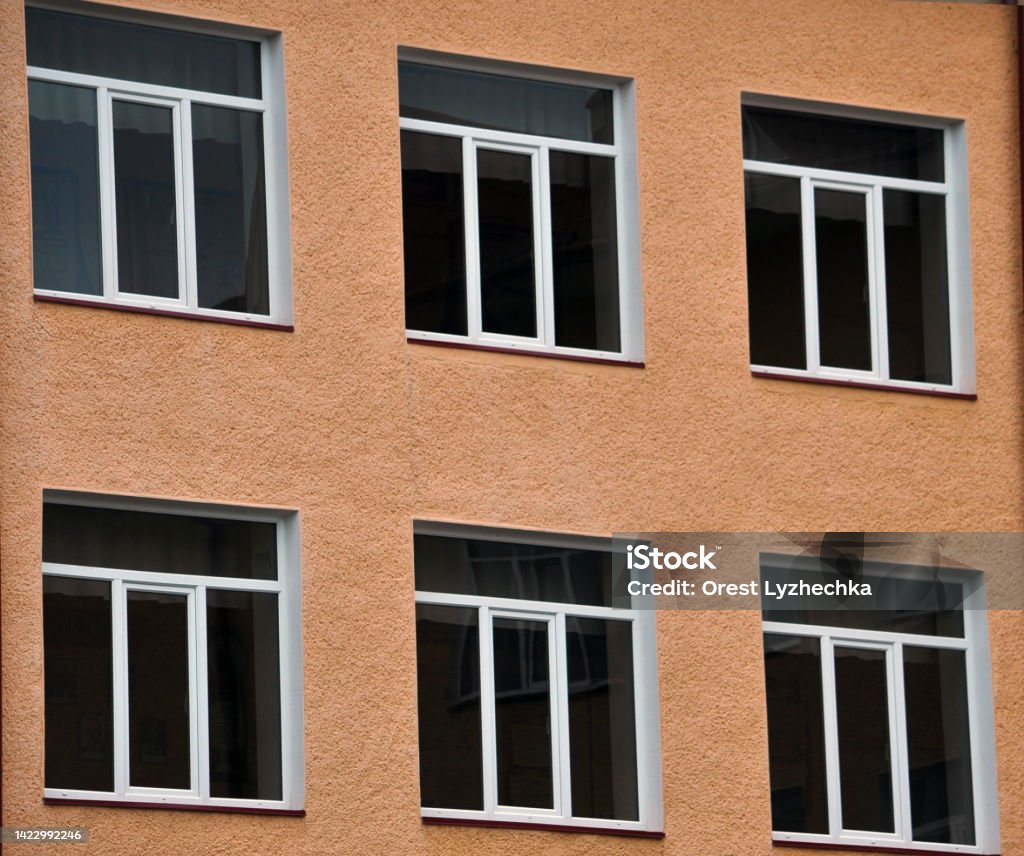 View from the street on the metal-plastic windows View from the street on the windows of metal-plastic Architecture Stock Photo