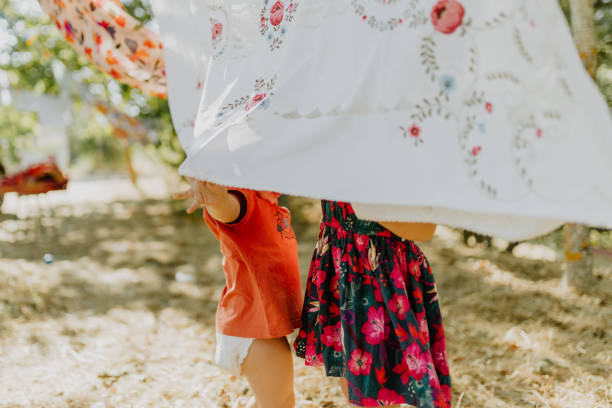 istock Children Playing With Hanging Clothes 1422992660