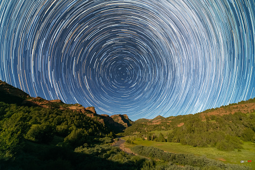 Night landscape, star trails over the mountains.