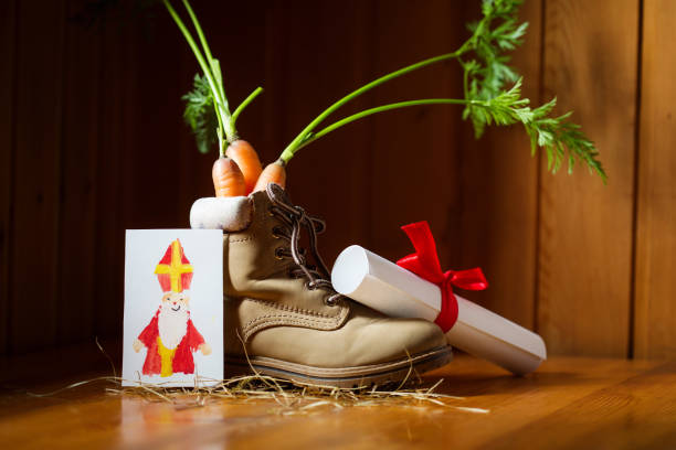 shoe with carrots for amerigo's horse, letter and paper art card for st. nicholas for traditional dutch holiday sinterklaas or for christmas. craft for kids - sinterklaas stockfoto's en -beelden