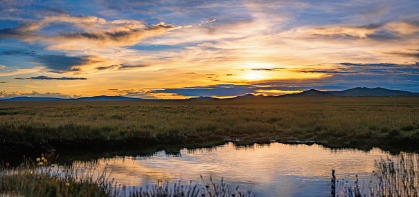 Sunset on grassland wetland, taken in Chadan Wetland, Zaduo County, Qinghai Province, China in August 2022