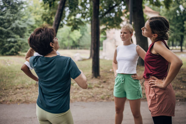 istock Women exercising together in park 1422999066