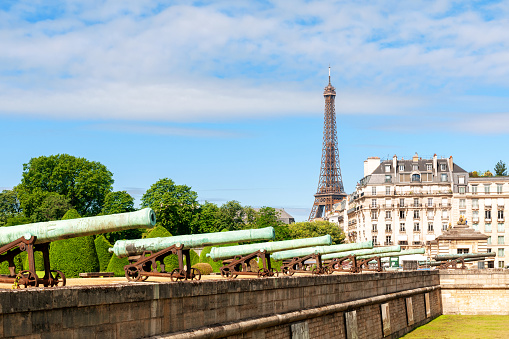 View on Eiffel tower with Les Invalides canons in foreground. Paris