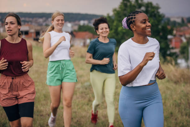 istock Female friends jogging in nature 1423001257