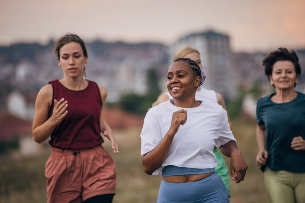 istock Female friends jogging in nature 1423001321