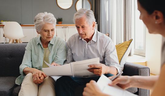 Senior couple writing will, inheritance and life insurance documents or contract with lawyer planning retirement. Pension fund, finance and financial investment with legal advisor for home mortgage