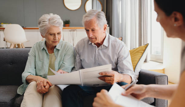 Senior couple writing will, inheritance and life insurance documents or contract with lawyer planning retirement. Pension fund, finance and financial investment with legal advisor for home mortgage stock photo