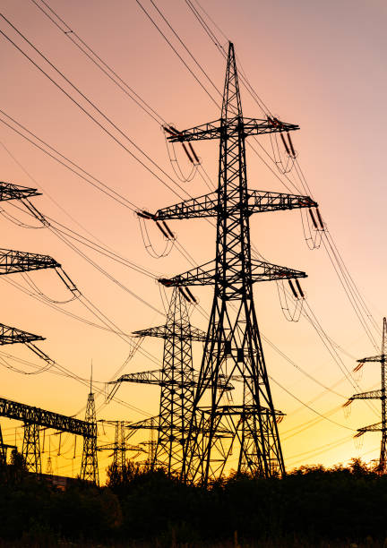 istock Electricity engineering constructrions supply. Dark shadows of electrical power towers. 1423002596