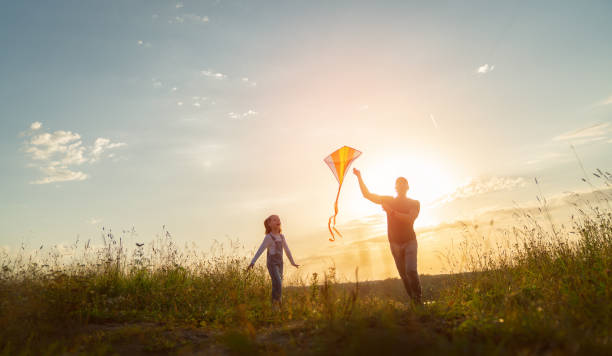 istock Happy family at sunset 1423004916