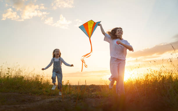 istock Happy kids with kite 1423004918
