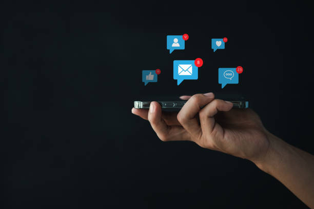 istock A person holding a smartphone with a popup application icon, using a smartphone application to communicate messages and play social media, using technology over the Internet communication network. 1423005828