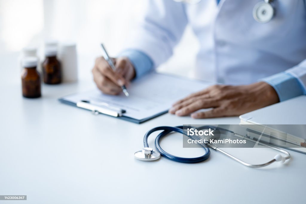 close up, the doctor's stethoscope is placed on the doctor's desk in the hospital examination room, the concept of treatment and symptomatic medication dispensing by the pharmacist. Healthcare And Medicine Stock Photo