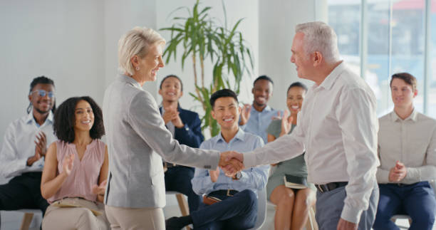 istock Handshake, workshop partnership or success collaboration in global company with clapping diversity office teamwork. Ceo, manager or leader in deal, thank you or welcome conference for business woman 1423007504