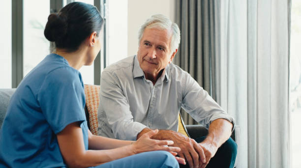 retirement home, elderly and healthcare caregiver taking care of senior man for his health, support and wellness. physiotherapy, doctor or nurse listening to old patient for medical problems - patient retirement senior adult hospital imagens e fotografias de stock