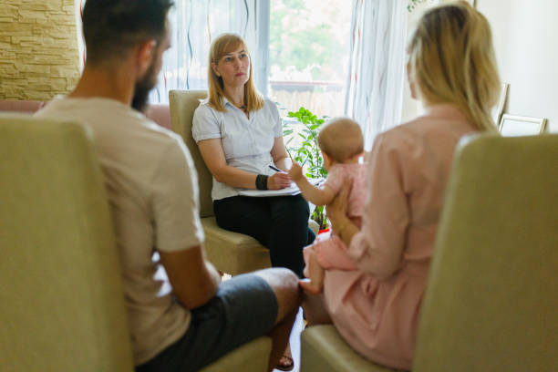 Couple with a baby on a therapy stock photo