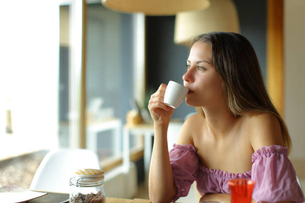istock Young woman drinking coffee in a restaurant 1423008196