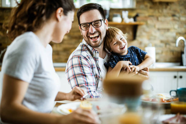istock Cheerful family having fun while talking during breakfast at home. 1423008447