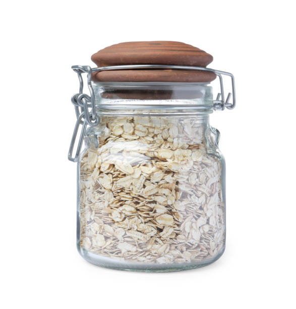 istock Raw oatmeal in glass jar isolated on white 1423008602