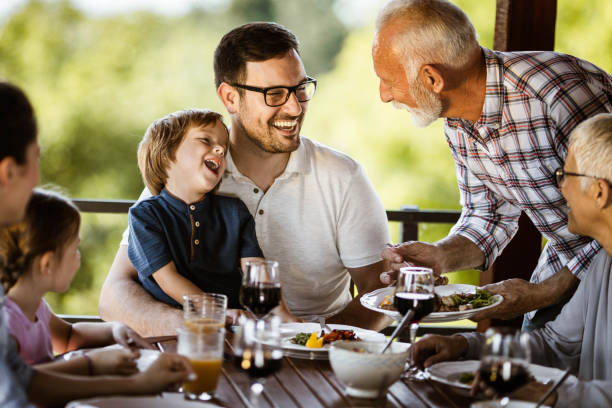 istock Happy extended family talking during lunch time on a balcony. 1423008809